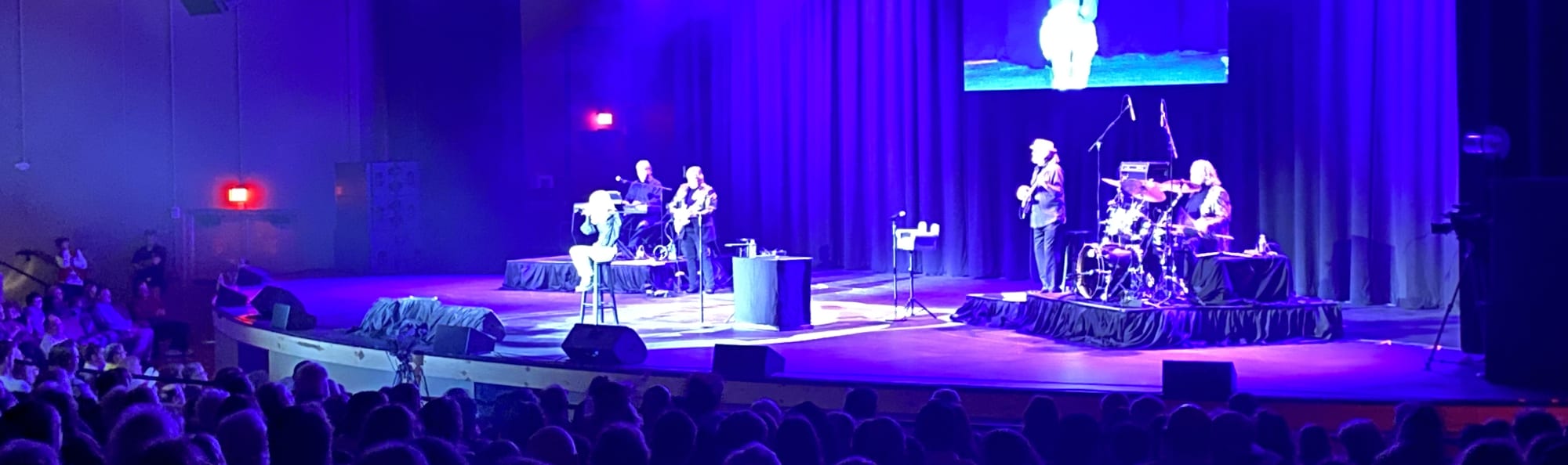 signer on stage in chair washed out by the lights Scranton